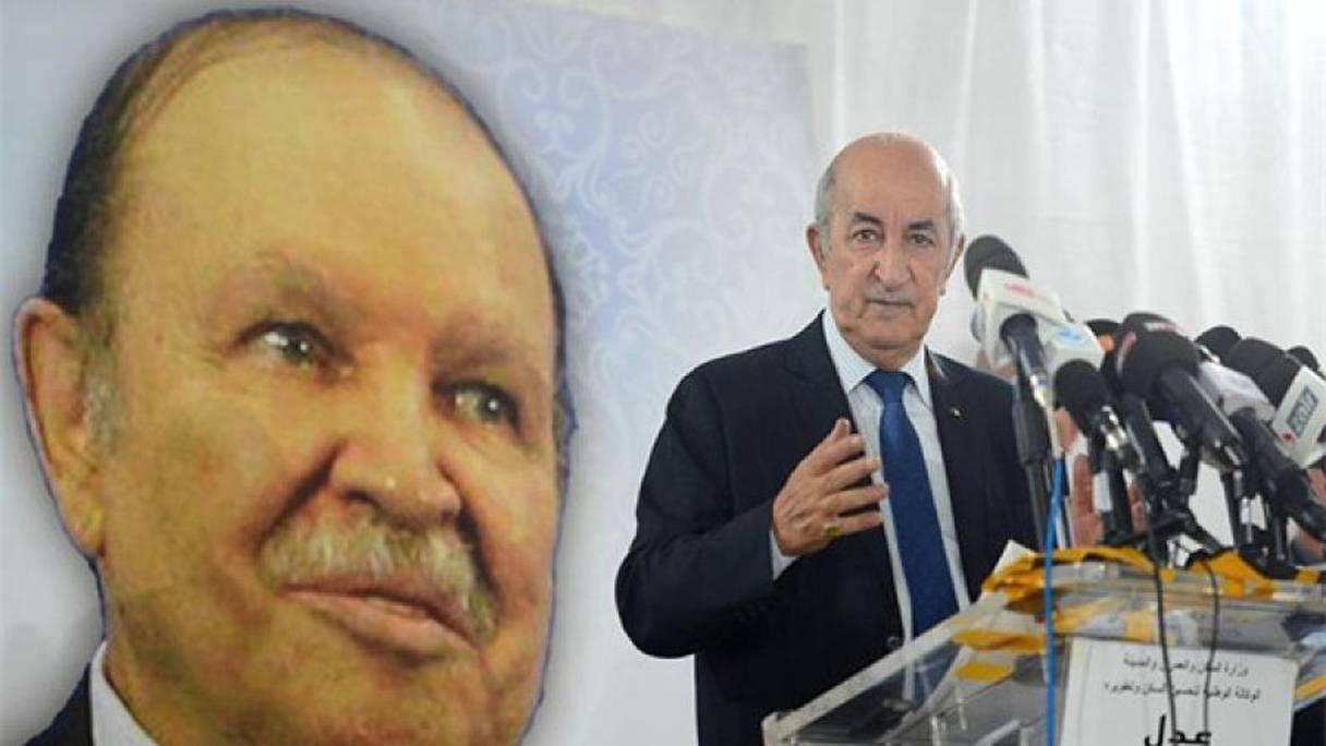 الرئيس الجزائري عبد المجيد تبون وخلفه صورة لخلفه المعزول عبد العزيز بوتفليقة
